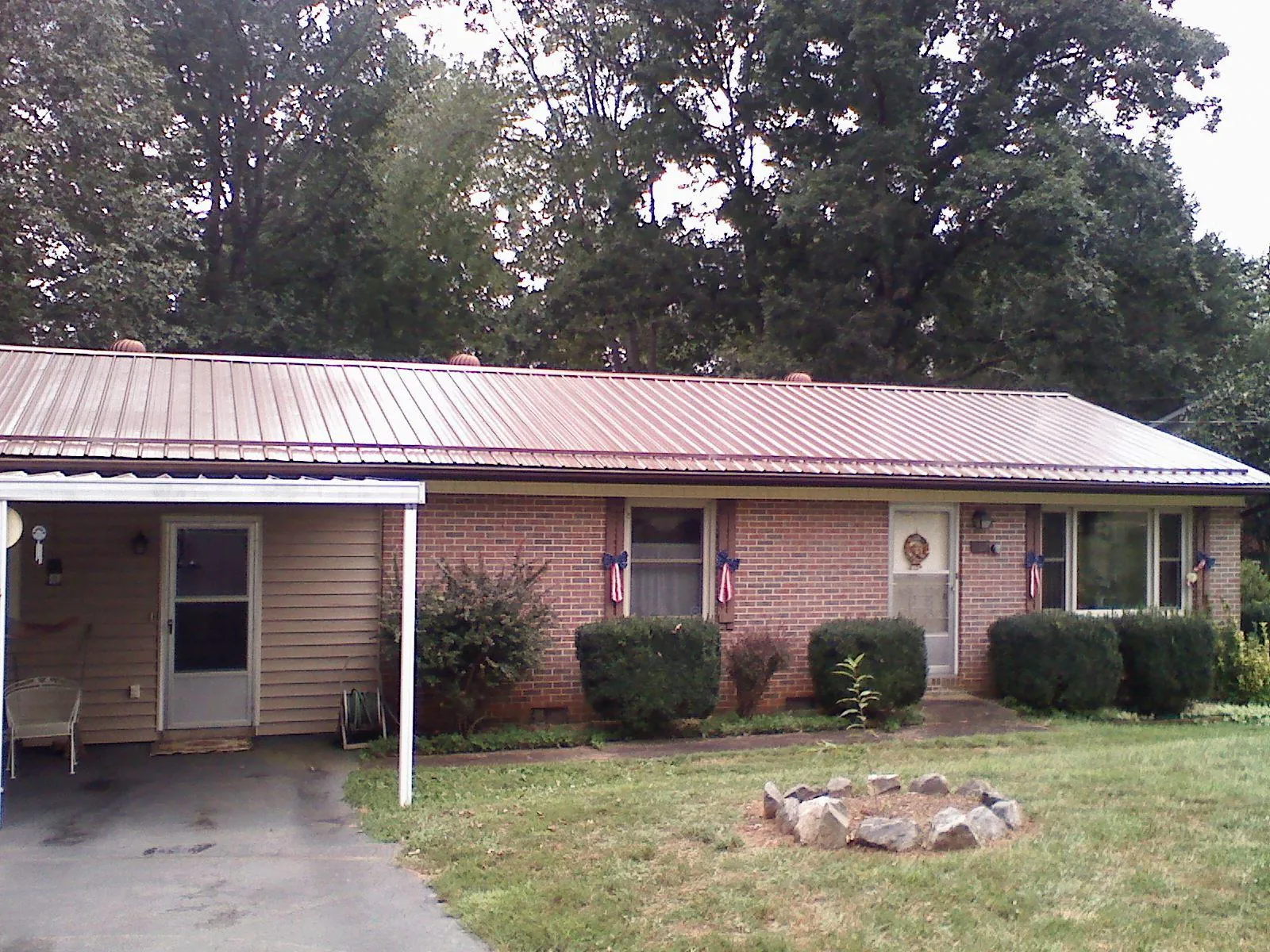Bronze metal roof and carport on a brick ranch home — Roof Repair work by our crew in Neffs